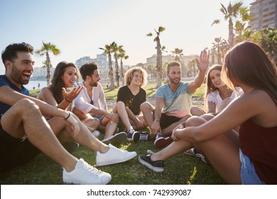 Group Of Friends Sitting In Circle Talking Outside