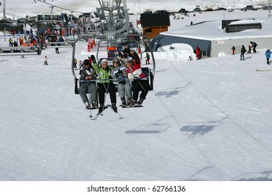 Group Of Friends Sitting On A Chairlift