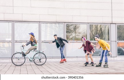 Group Of Friends Skating And Cycling In An Urban Area - Cheerful Teenagers Having Fun Outdoors