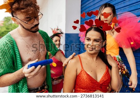 Group of friends smiling while applying sunscreen on each other during carnival preparation before a Brazilian street celebration.