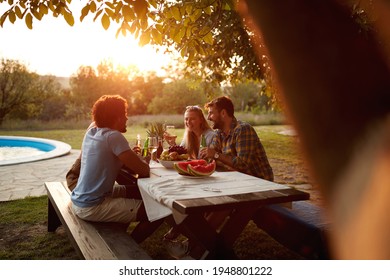  group of friends socializing at sunset by the swimming pool outdoor in nature - Powered by Shutterstock