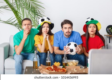 Group Of Friends Sport Fans Watching Match In Colorful Shirts Nervous