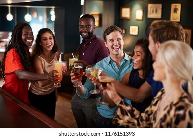 Group Of Friends Standing At Bar And Making A Toast On Night Out - Powered by Shutterstock