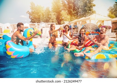 Group of friends in swimsuit enjoy in a swimming pool - Shutterstock ID 2126249477