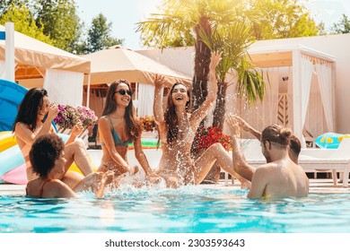 Group of friends in swimsuit enjoy in a swimming pool - Powered by Shutterstock