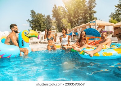 Group of friends in swimsuit enjoy in a swimming pool - Shutterstock ID 2303593659