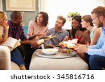 Group Of Friends Taking Part In Book Club At Home