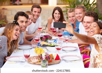 Group Of Friends Taking Selfie During Lunch Outdoors