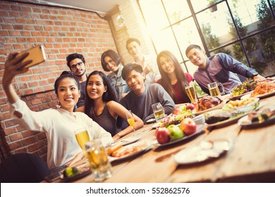 A group of friends are taking selfie friend told others He's coming to the party tonight.