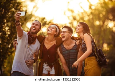 Group of friends taking selfie on their way to festival - Powered by Shutterstock