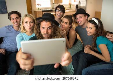 Group Of Friends Taking A Selfie On A Tablet And Make Goofy Faces