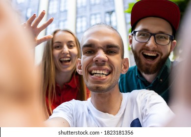 Group of friends taking a stroll on city's street in summer day. Handicapped man with his friends having fun. Inclusion and diversity concept, normal lifestyle of special groups of society. - Shutterstock ID 1823181356