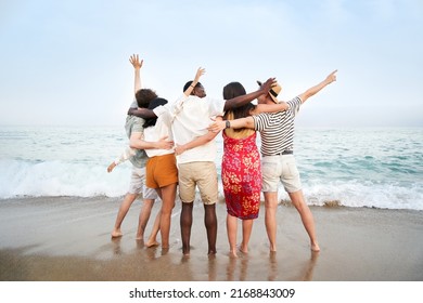 A Group Of Friends With Their Backs To The Camera Enjoying The Sea Together - Multicultural Multinational Happy People Hugging Into The Sun Carefree And Happiness, Vacation On Sea.