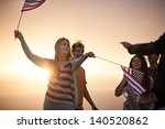 Group of Friends in their twenties dancing on the Beach at Sunset in California