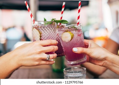 Group Of Friends Toasting With Lavender Cocktails