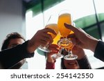 Group Of Friends Toasting In Tavern