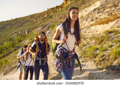 Group Of Friends Tourists With Backpacks Traveler In The Mountains On A Hike Hiking Along The Route In Nature In Summer. Outdoor Activities Adventure For People.