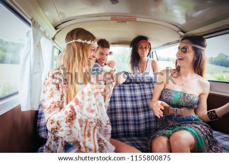 Group of friends travelling with a vintage minivan - Hippies driving into the nature