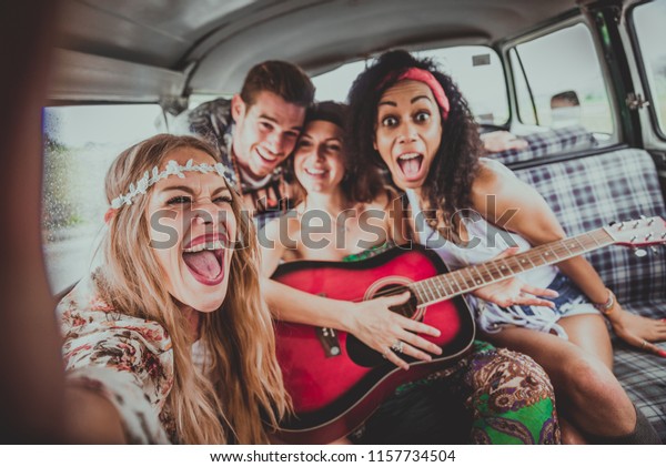 Group of friends travelling with a vintage\
minivan - Hippies driving into the\
nature