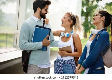 Group of friends, university students smiling, preparing for exam outdoors