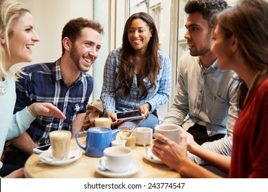 Group Of Friends In CafÃ?Â¢?? Using Digital Devices