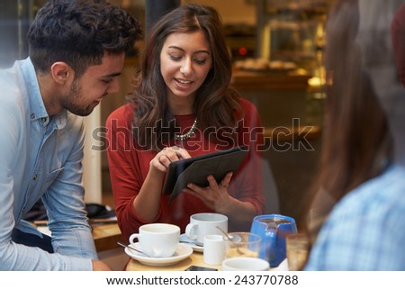 Group Of Friends In CafÃ?Â¢?? Using Digital Tablet