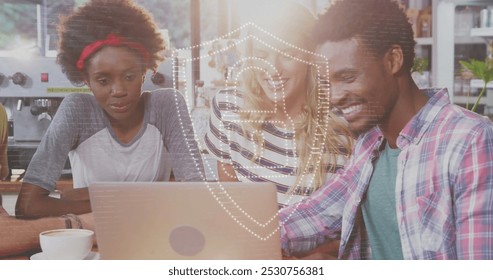 A group of friends are using a laptop while enjoying a cup of coffee in a cafe. A digital icon of an online security padlock is glowing on a grey background, symbolizing global networking and online - Powered by Shutterstock