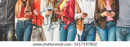 Group of friends using smart mobile phones app - Teenagers addiction to new technology trends - Concept of youth, tech, social and friendship - Focus on center hands 