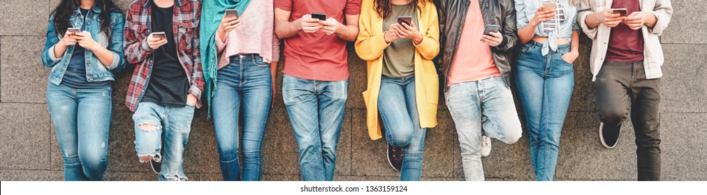 Group of friends using their smart mobile smartphones outdoor - Millennial young people addicted to new technology trends apps - Concept of people, tech, social media, generation z and youth lifestyle