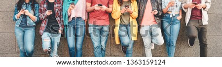 Group of friends using their smart mobile smartphones outdoor - Millennial young people addicted to new technology trends apps - Concept of people, tech, social media, generation z and youth lifestyle