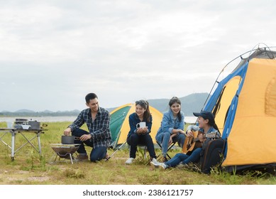 Group of friends walking on an adventure in the forest Camping, relaxing, happy, playing guitar, singing, drinking coffee. - Powered by Shutterstock