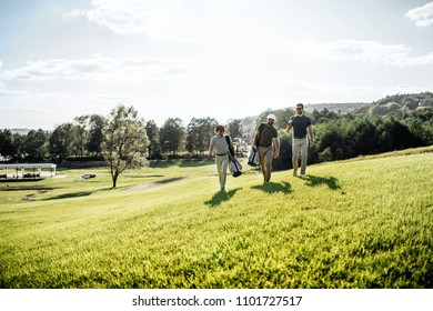 Group Of Friends Walking On The Golf Course