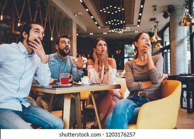 Group of friends watching game in cafe