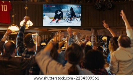 Group of Friends Watching a Live Ice Hockey Match on TV in a Sports Bar. Excited Fans Cheering and Shouting. Young People Celebrating When Team Scores a Goal and Wins the World Tournament.