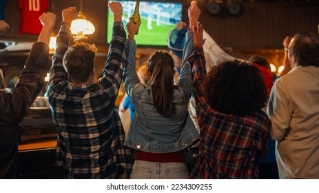Group of Friends Watching a Live Soccer Match on TV in a Sports Bar. Excited Fans Cheering and Shouting. Young People Celebrating When Team Scores a Goal and Wins the Football World Cup.