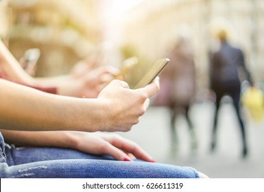 Group Of Friends Watching Mobile Phones In City - Young People Are Addicted To New Technology Trends - Alienation Moment For New Generation Problem - Focus On First Hand - Warm Filter