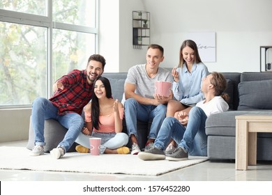 Group Of Friends Watching Movie At Home