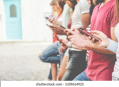 Group of friends watching smart mobile phones - Teenagers addiction to new technology trends - Concept of youth, tech, social and friendship - Focus on close-up phone