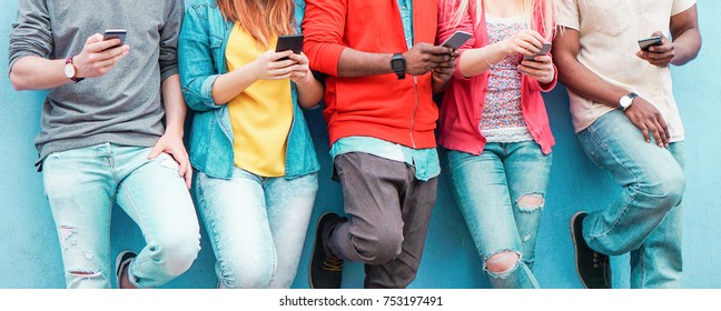 Group of friends watching smart mobile phones - Teenagers addiction to new technology trends - Concept of youth, tech, social and friendship - Main focus on center hands 