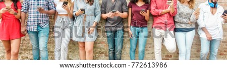 Group of friends watching smart mobile phones - Teenagers addiction to new technology trends - Concept of youth, tech, social and friendship - Main focus on center hands