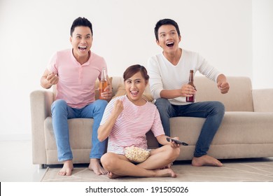 Group Of Friends Watching Sport Game On Tv