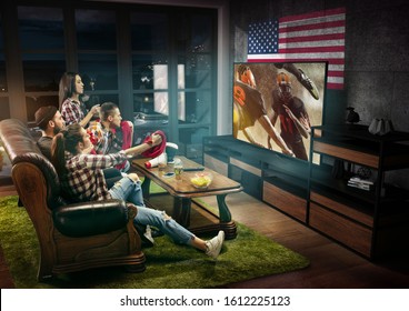 Group of friends watching TV, american football match, championship. Emotional men and women cheering for favourite team, look on fighting for ball. Concept of friendship, sport, competition, emotions