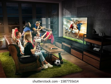 Group Of Friends Watching TV, Football Match, Sport Together. Emotional Men And Women Cheering For Favourite Team, Look On Goal And Fighting For Ball. Concept Of Friendship, Leisure Activity, Emotions