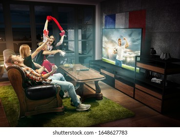 Group Of Friends Watching TV, Teens Football Match, Championship, Sport Games. Emotional Men And Women Cheering For Favourite Soccer Team Of France. Concept Of Friendship, Sport, Competition, Emotions