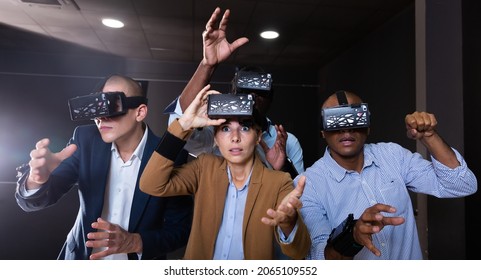 Group Of Friends Are Wearing Virtual Reality Goggles In The Quest Room