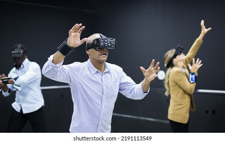 Group Of Friends Are Wearing Virtual Reality Goggles In The Quest Room