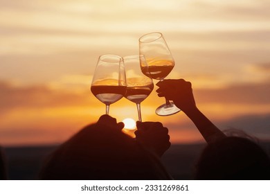 Group of friends with white wine in hands clinking with glasses. Close-up of hands and drinks. Beautiful scenic sunset.	
 - Powered by Shutterstock