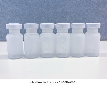 Group Of Frosted Vials With Crimp Caps Taken Out From A Container With Dry Ice After Professional, Medical Transport. Selected Focus.