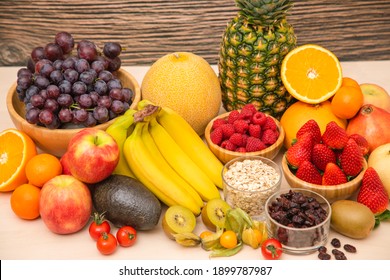 Group Fruits mixed with banana, orange, strawberry and nuts, concept health food and diet, vegetarian food in the top view on the wood table. - Shutterstock ID 1899787987