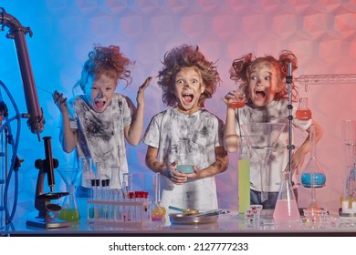 Group of funny kids with matted hair scream in a chemical laboratory after boom from an unsuccessful experiment. Science experiments and children. 